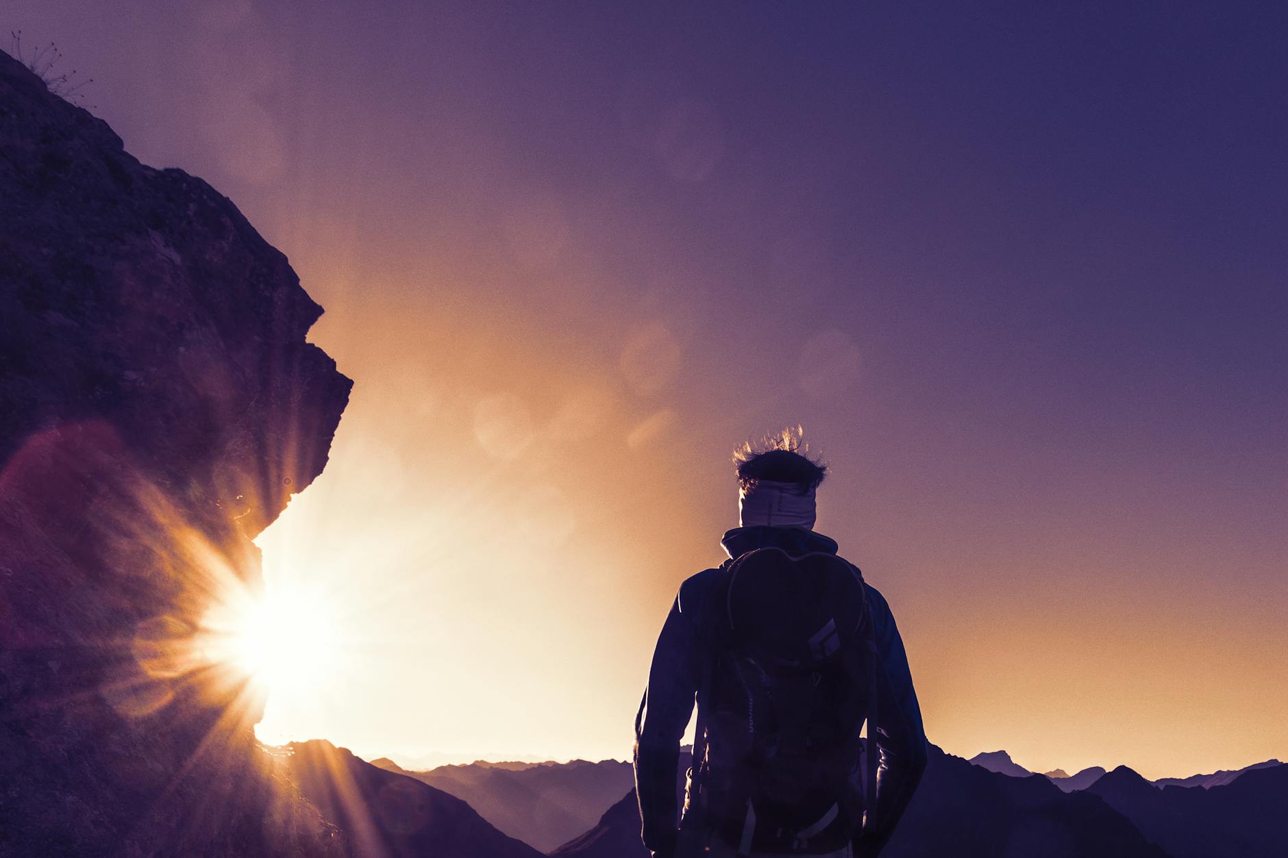 Woman looking determined at a bright sunrise representing the hard work and breakthrough energy of the 1144 angel number