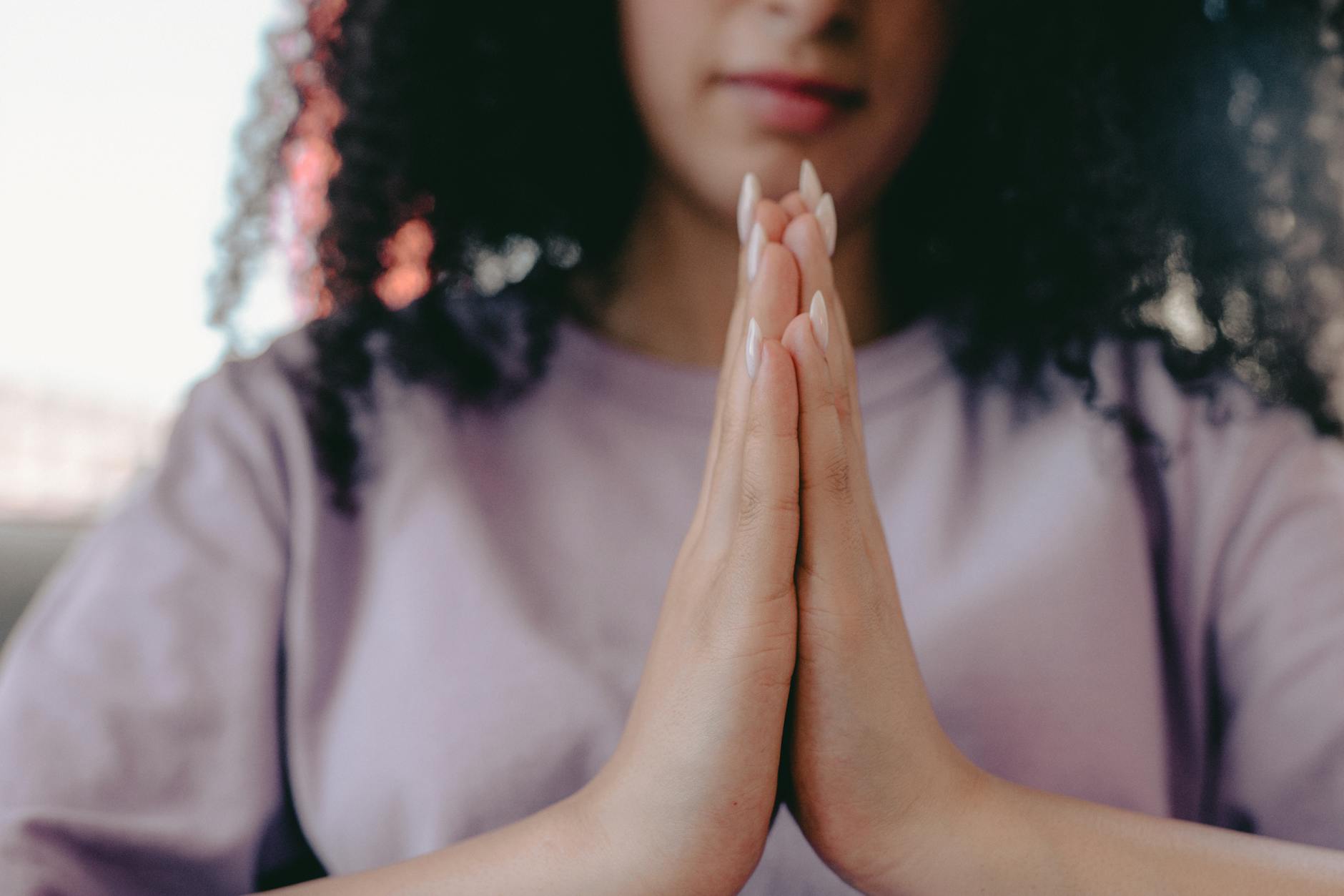 Woman meditating peacefully with the number 220 glowing in soft purple light