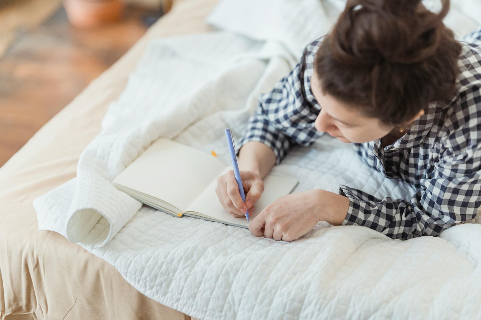 Woman journaling in a peaceful space — the contemplative practice that opens one to the Ascended Master guidance flowing through angel number 355