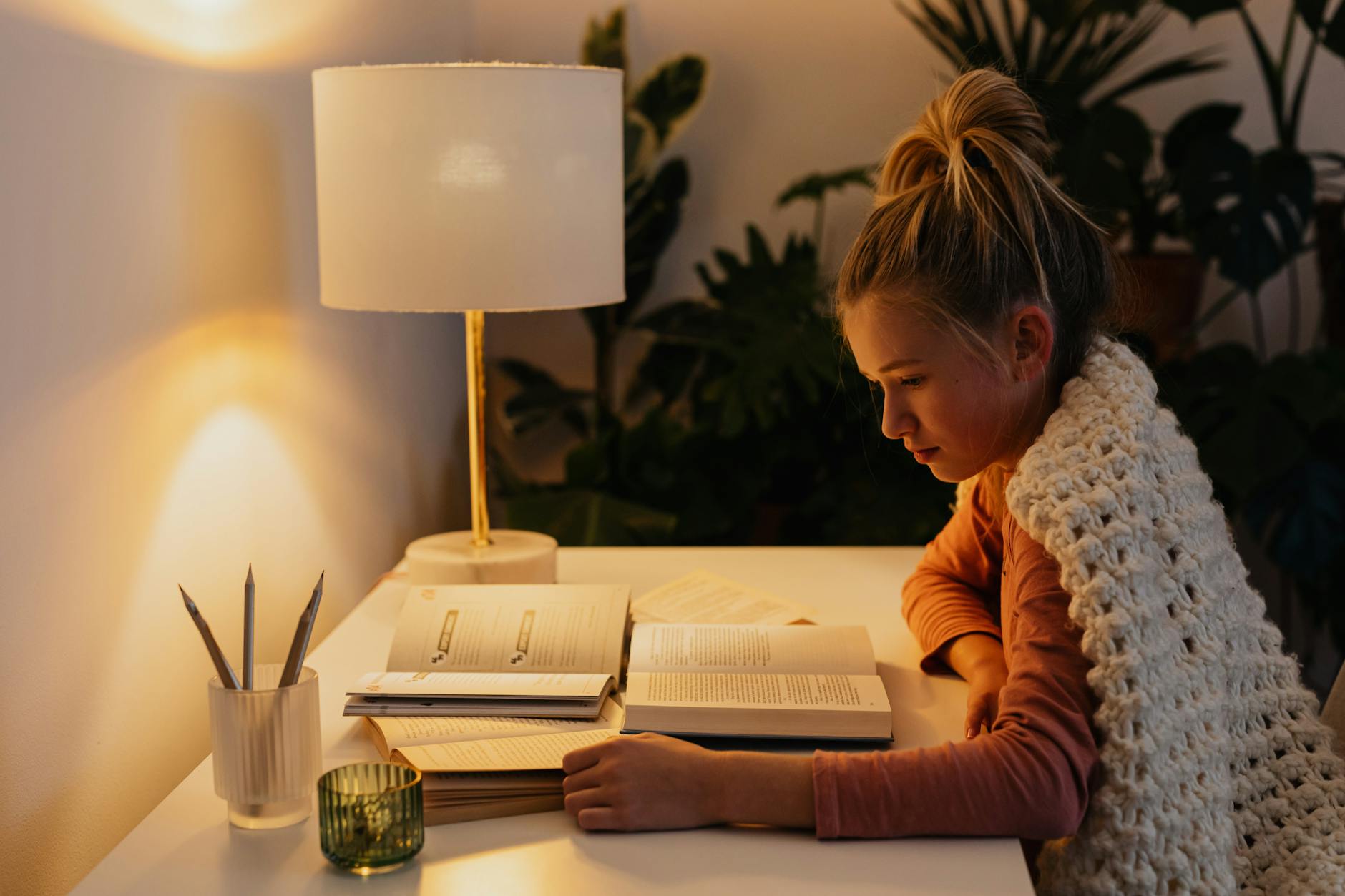 Woman reading by soft light representing the practical guidance and new beginning energy of the 411 angel number
