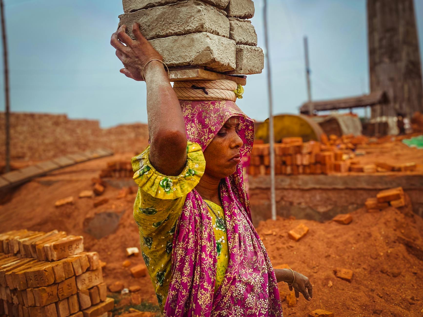 Woman building something with her hands in warm light representing the grounded determination of the 414 angel number