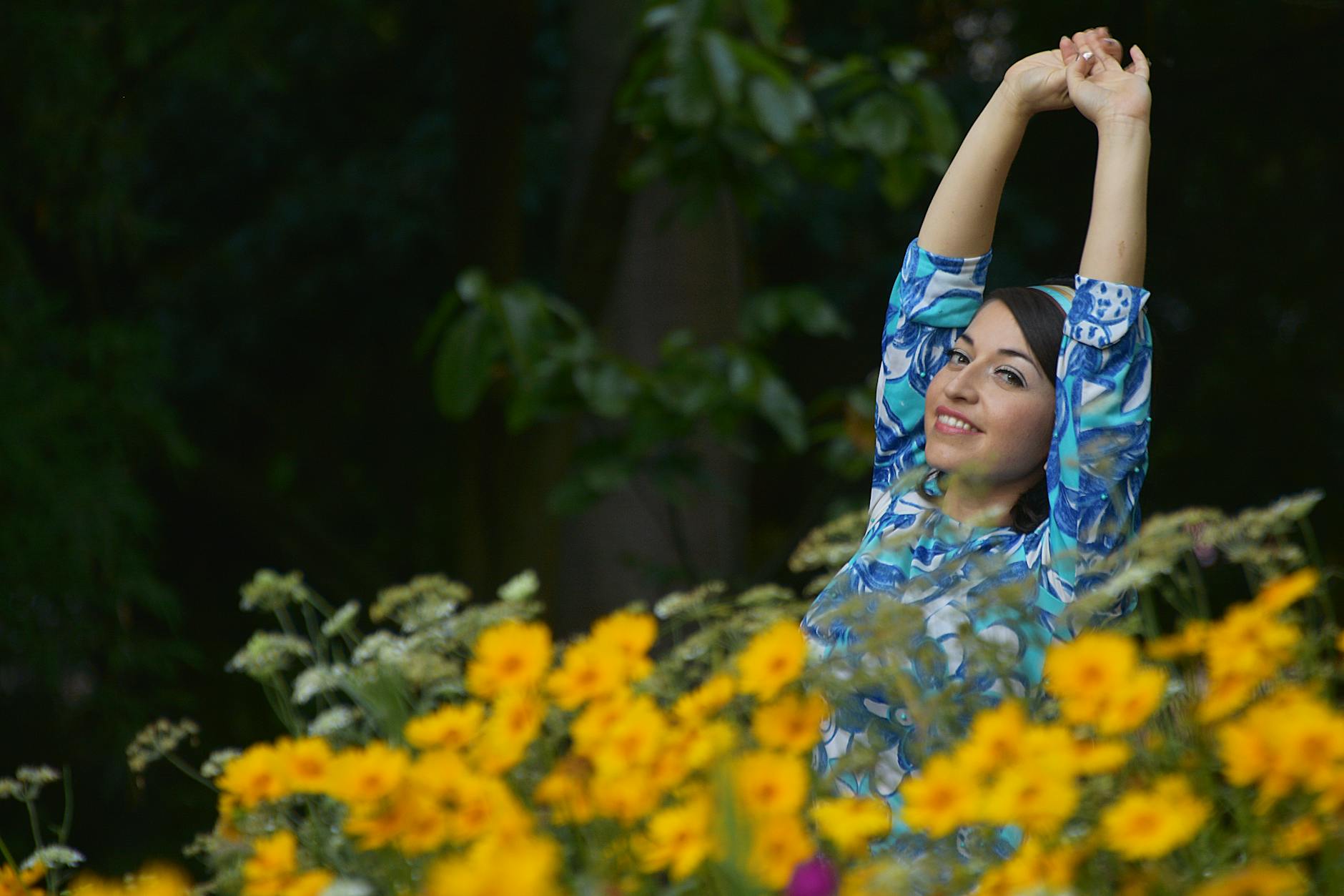 Woman radiant in natural surroundings — the embodiment of the joyful, spiritually guided transformation that angel number 5353 brings