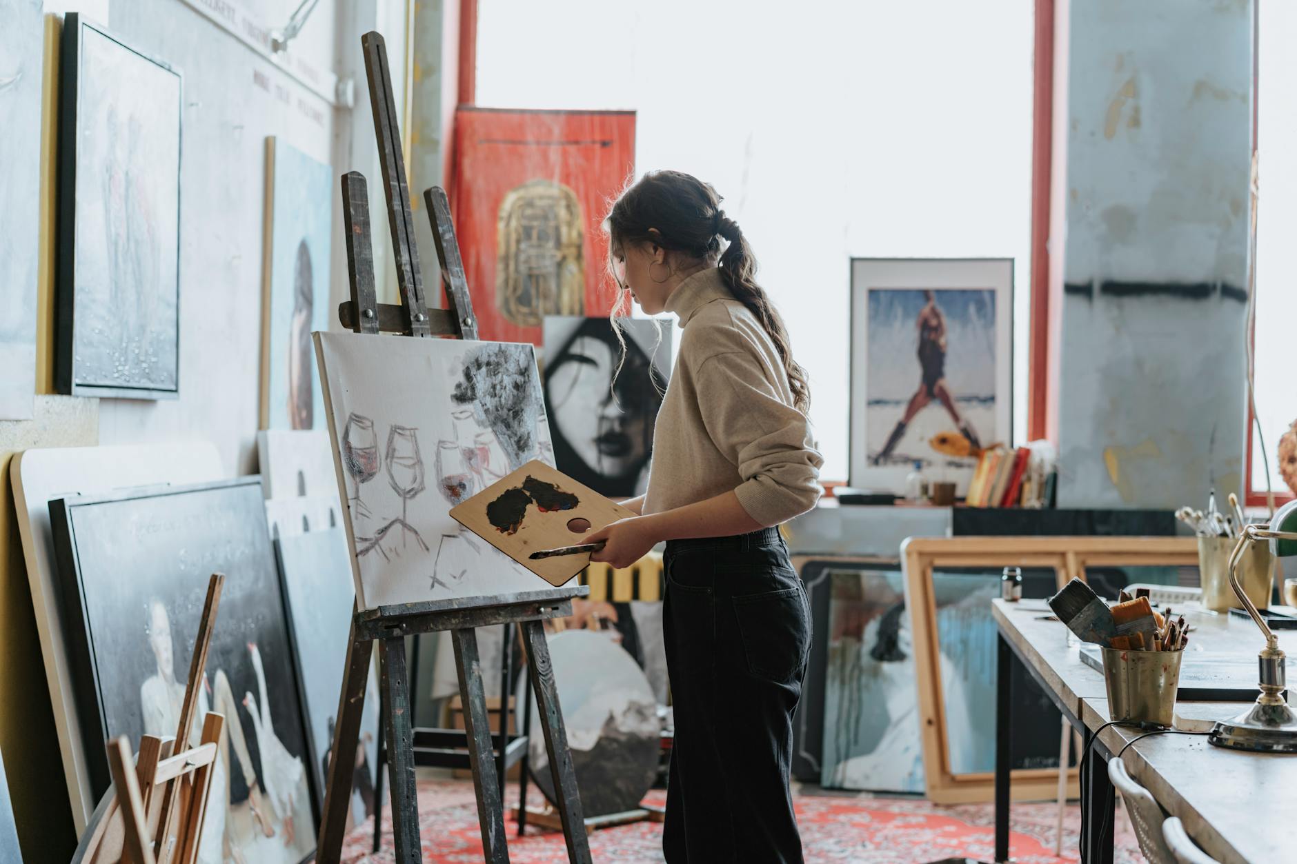 Woman engaged in creative work — embodying the joyful 3-energy that angel number 543 promises at the end of its arc of change and foundation