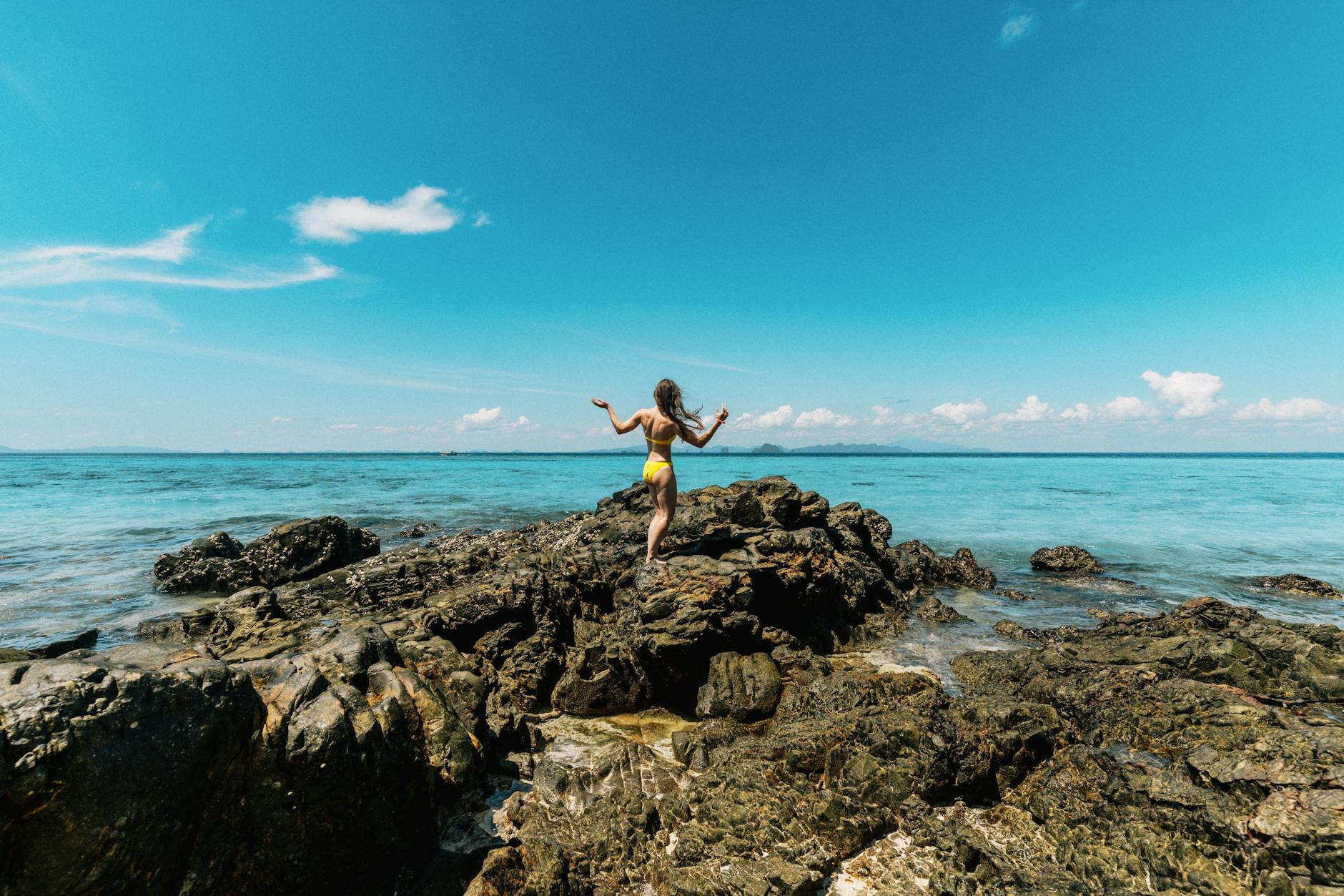 Woman leaping forward into brilliant open sky representing the extraordinary new beginning launched by powerful change in the 5511 angel number