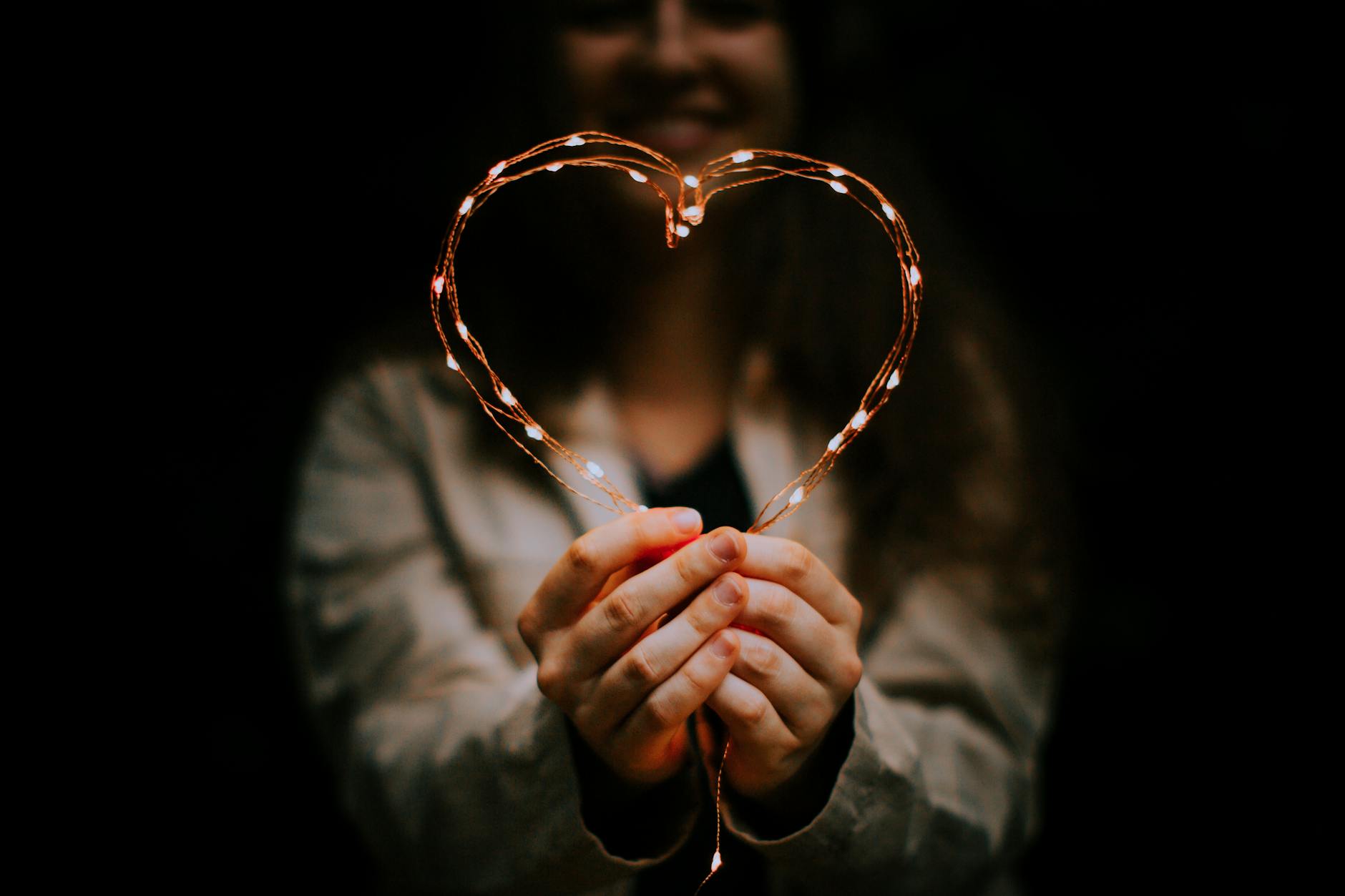 Woman in warm light of love and connection representing the heart-centred new beginning energy of the 616 angel number
