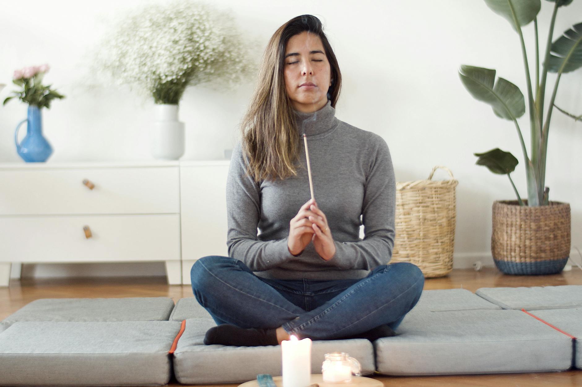 Woman meditating peacefully in nature with a sense of deep inner knowing representing the spiritual wisdom of the 7171 angel number