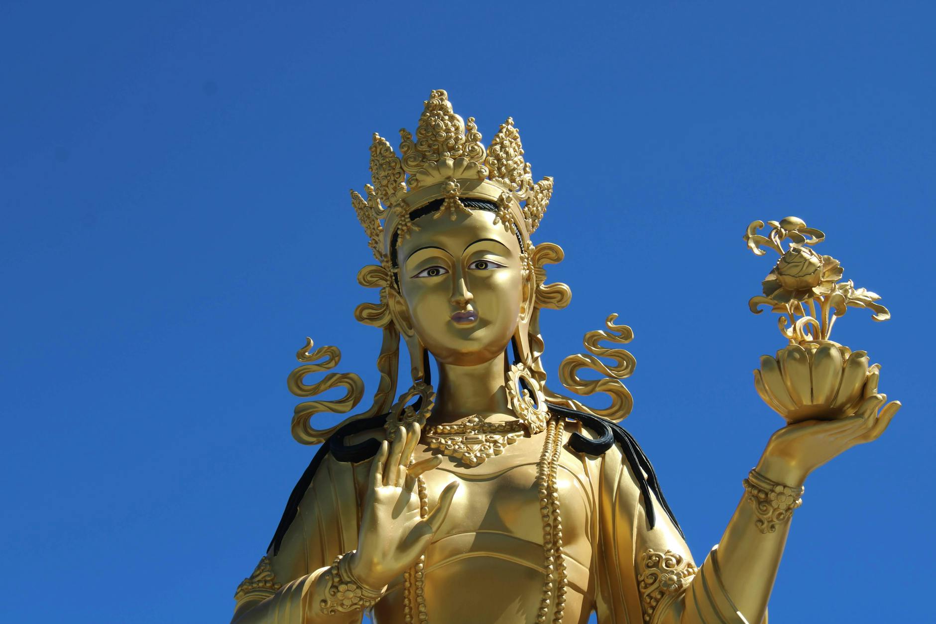 Woman with arms open in golden sunrise light representing the infinite abundance of the 888 angel number