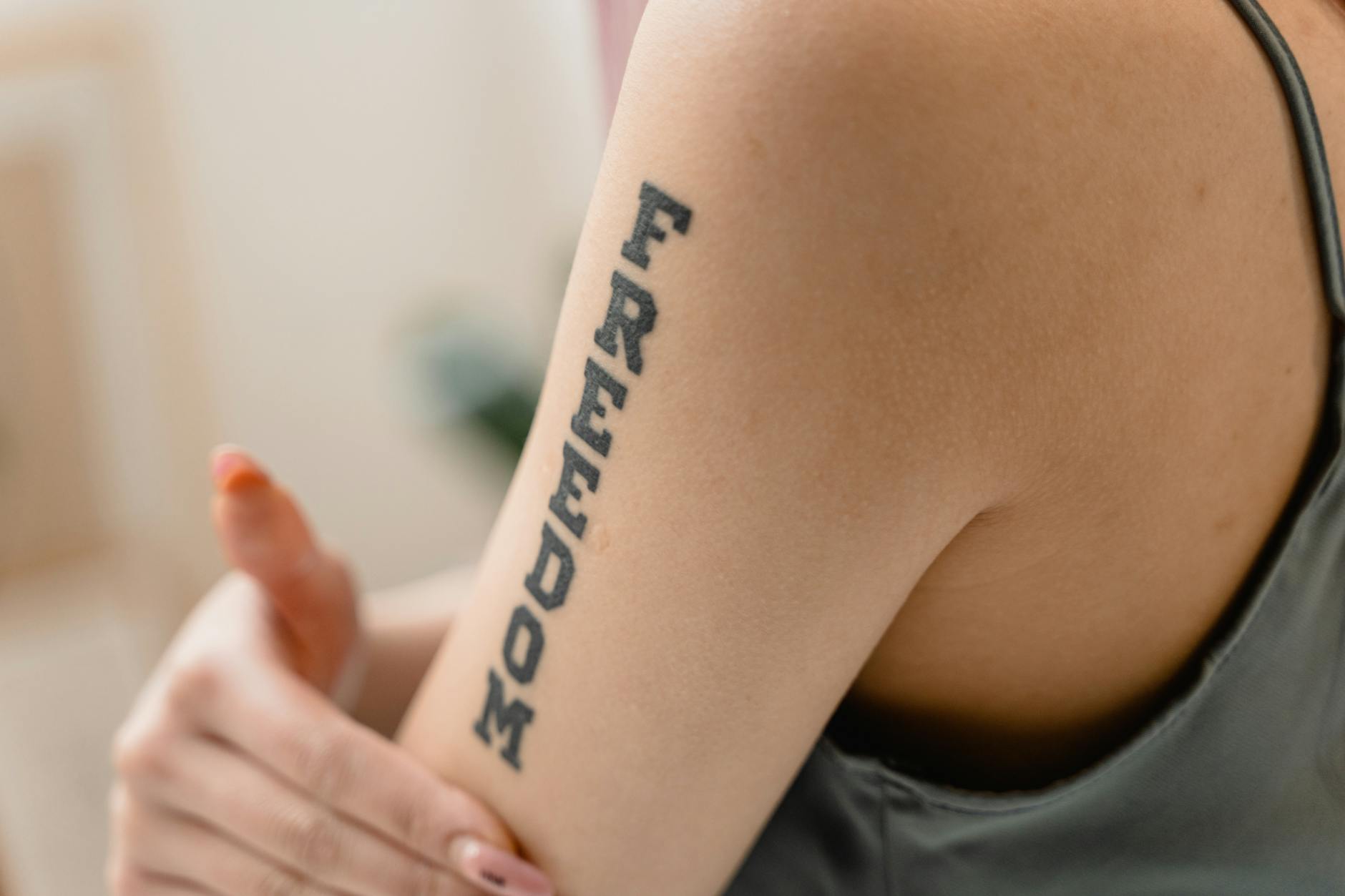Woman with a meaningful number tattoo on her wrist representing her spiritual journey and angel number connection